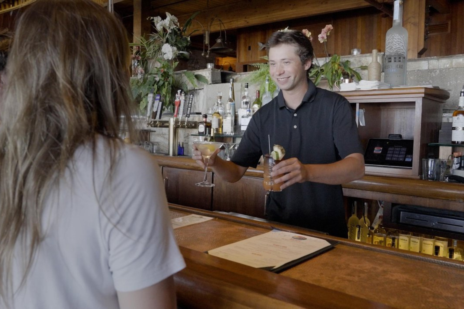 jake's on the lake bartender serving cocktails at bar